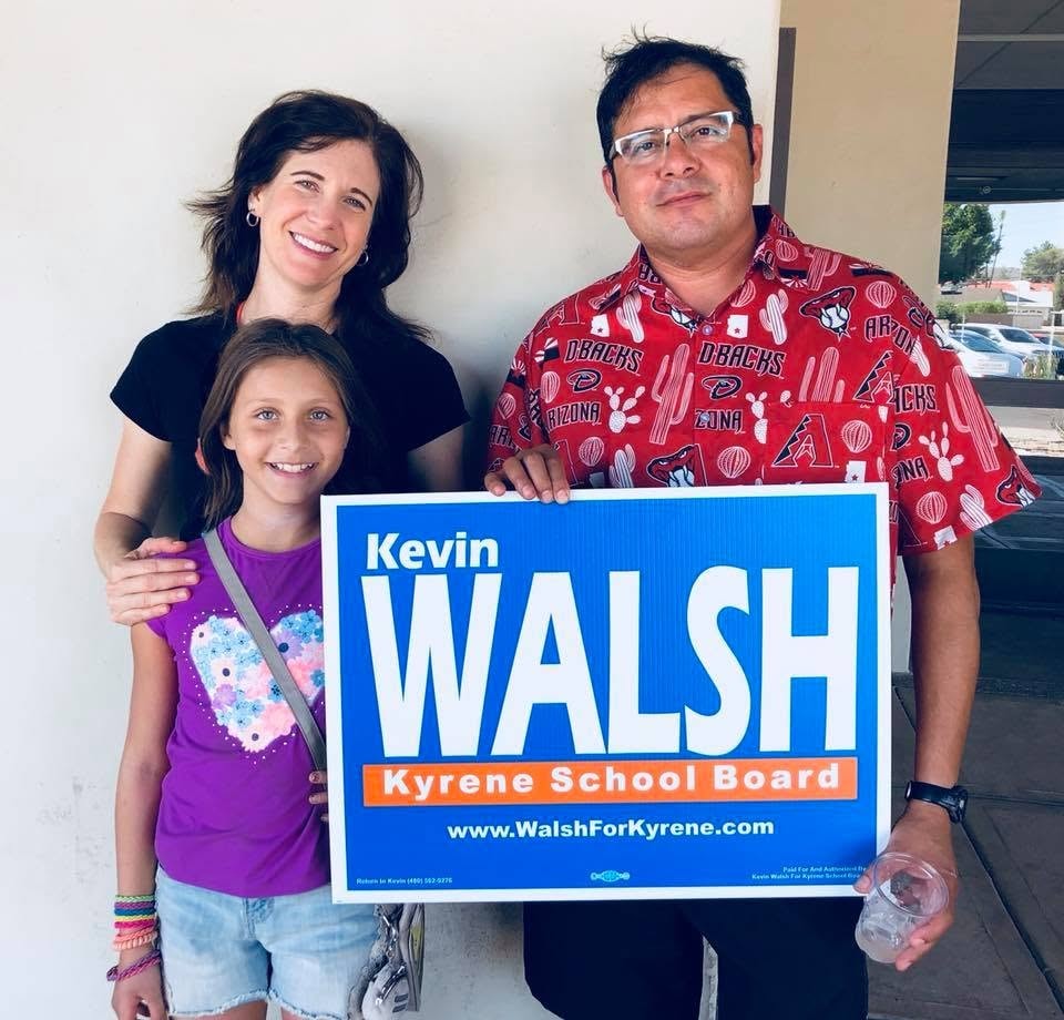Family holding a Kevin Walsh for Kyrene School Board sign