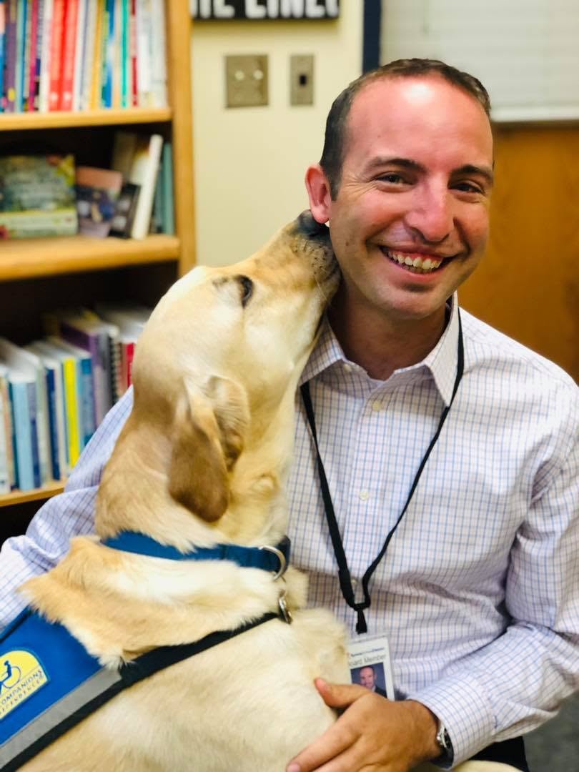 Kevin visiting a school with a service dog